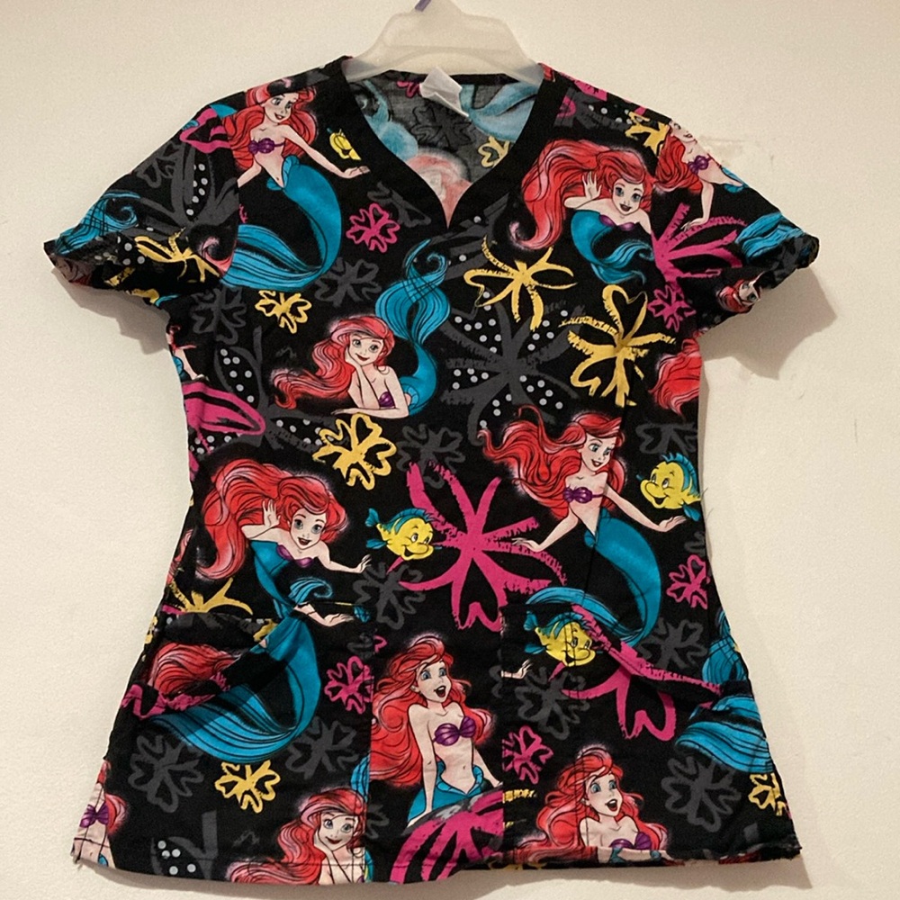 Bold Disney Ariel Scrub top in these beautiful colors. Front pockets and comfy